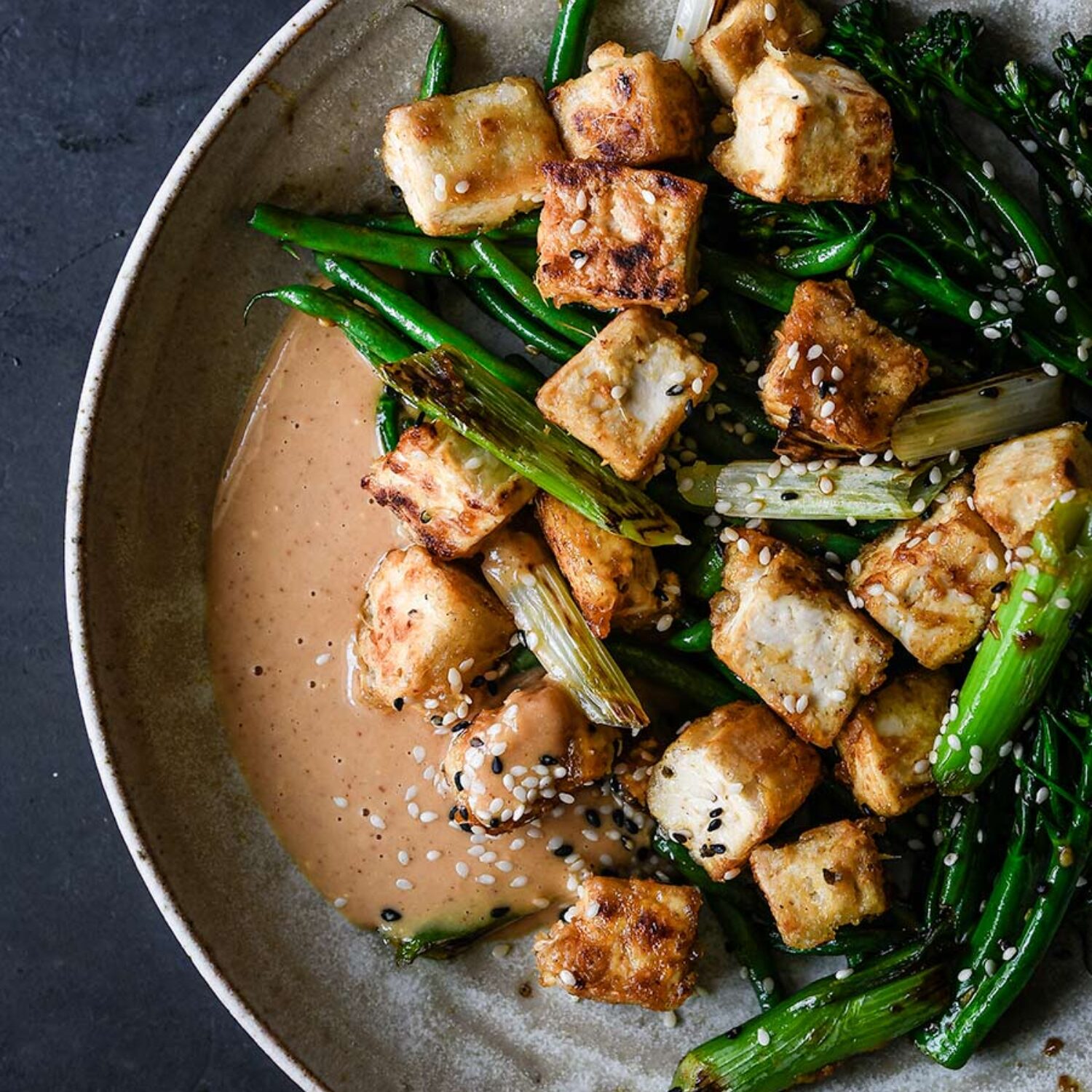 Crispy tofu, peanut sauce & sesame greens